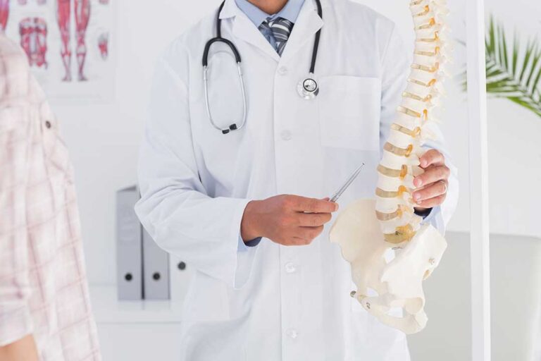 Person maintaining neutral posture at a desk with supported feet and relaxed shoulders.